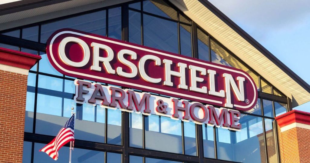  orschelin farm and home sign in white and red over the top of a building